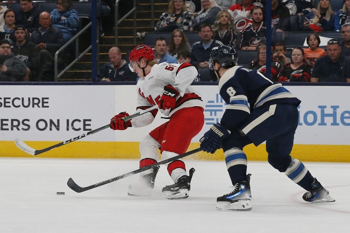 Apr 16, 2024; Columbus, Ohio, USA; Carolina Hurricanes right wing Jackson Blake (53) carries the puck as Columbus Blue Jackets defenseman Zach Werenski (8) defends during the first period at Nationwide Arena.