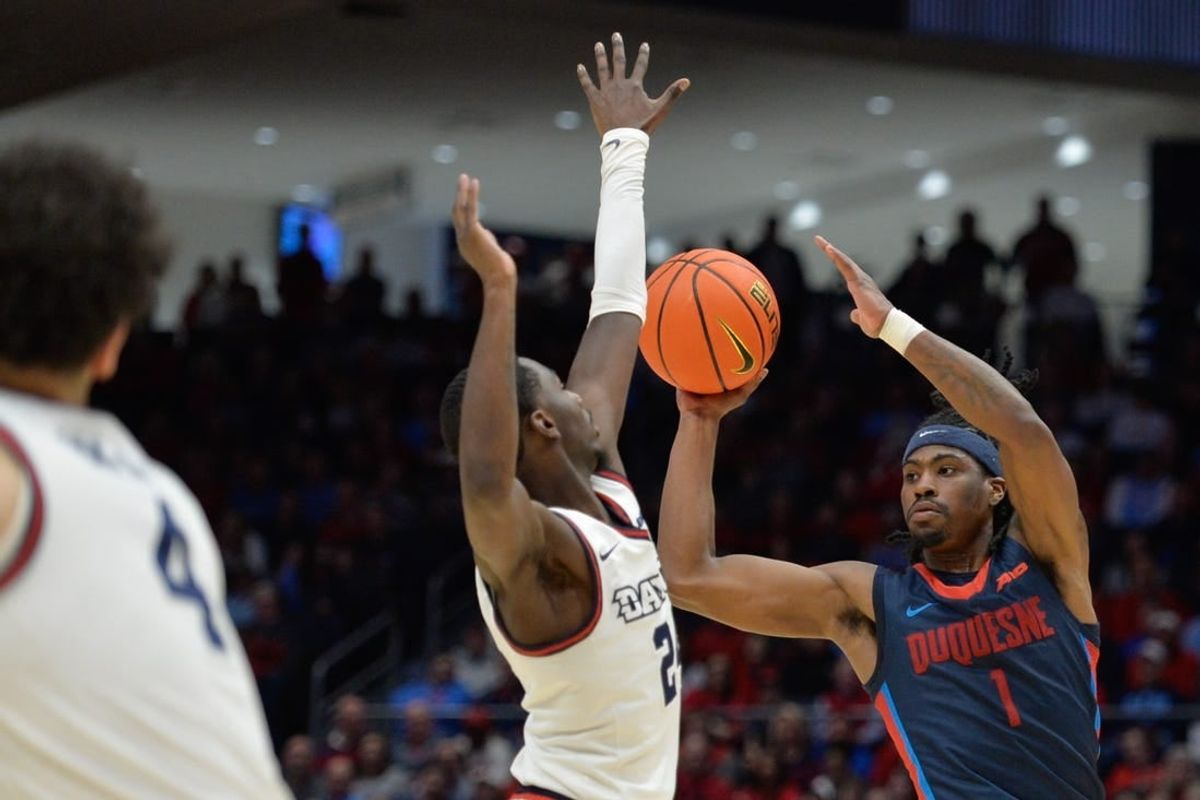 Feb 13, 2024; Dayton, Ohio, USA; Duquesne guard Jimmy Clark III (1) shoots the ball against Dayton Flyers guard Kobe Elvis (24) during the game at University of Dayton Arena.