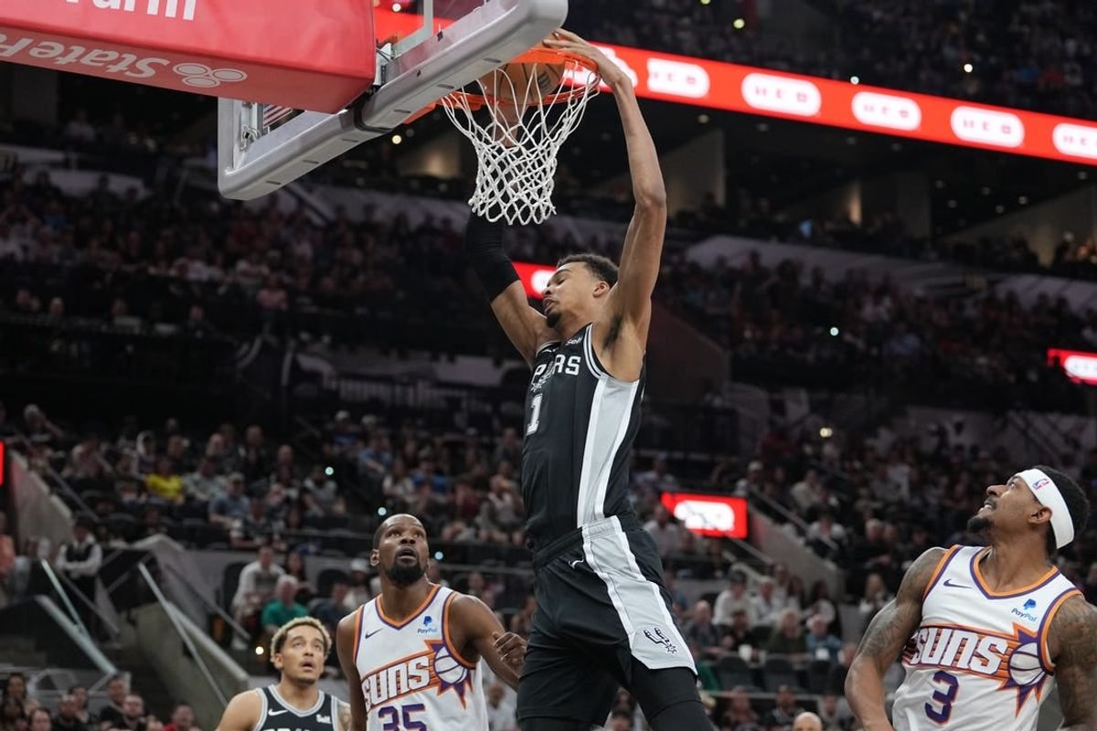 Mar 23, 2024; San Antonio, Texas, USA;  San Antonio Spurs center Victor Wembanyama (1) dunks the ball in front of Phoenix Suns forward Kevin Durant (35) and guard Bradley Beal (3) in the first half at Frost Bank Center.