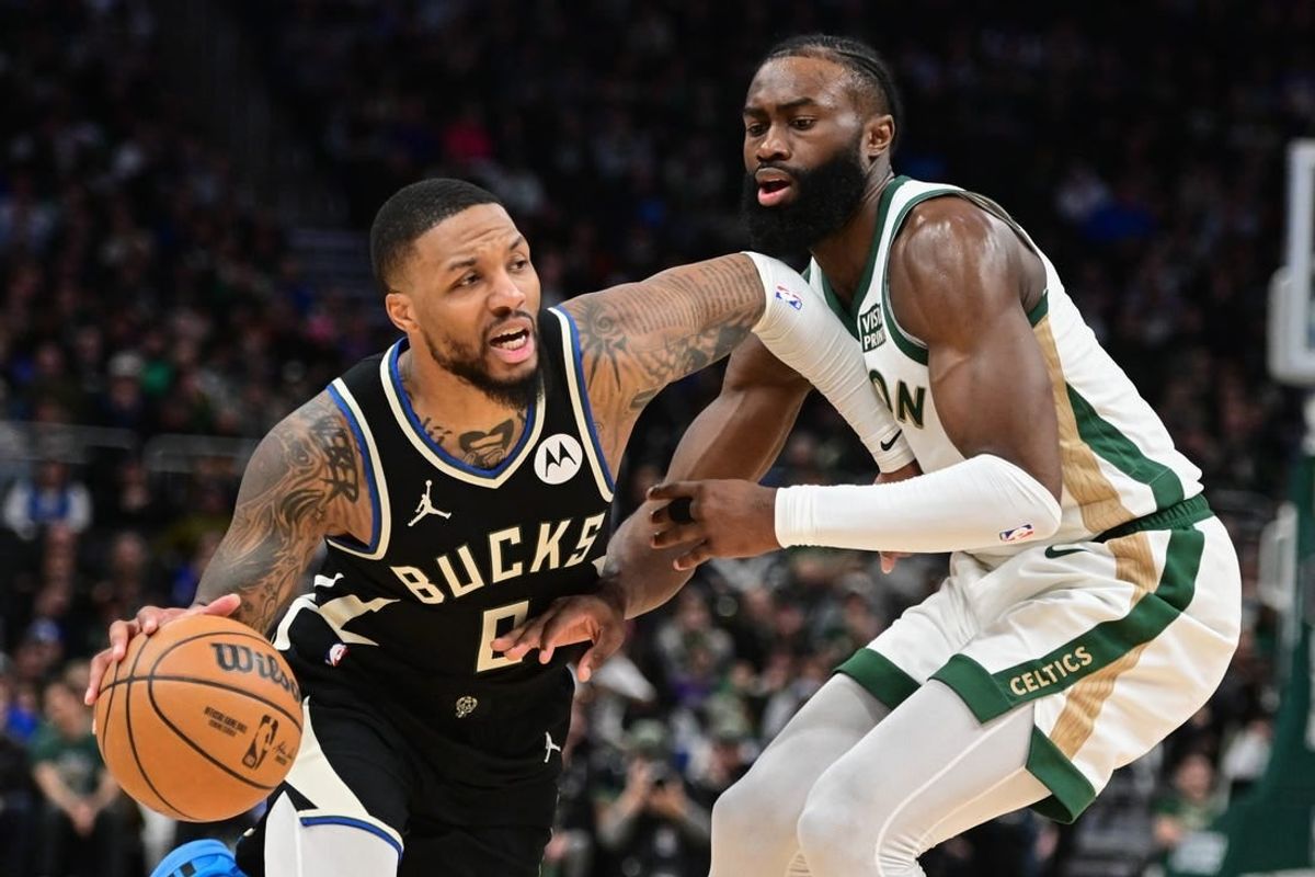 Jan 11, 2024; Milwaukee, Wisconsin, USA;  Milwaukee Bucks guard Damian Lillard (0) drives for the basket against Boston Celtics center Jaylen Brown (7) in the second quarter at Fiserv Forum.