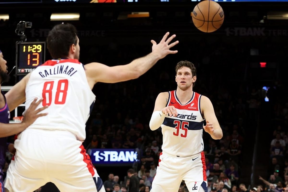 Dec 17, 2023; Phoenix, Arizona, USA; Washington Wizards center Mike Muscala (35) makes a pass to Washington Wizards forward Danilo Gallinari (88) against the Phoenix Suns during the first half at Footprint Center.