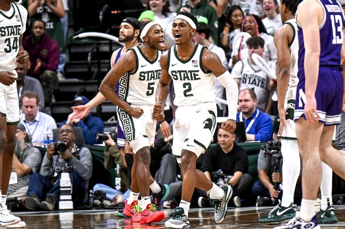 Michigan State's Tyson Walker, right, and Tre Holloman celebrate a Northwestern turnover during the second half on Wednesday, March 6, 2024, at the Breslin Center in East Lansing.