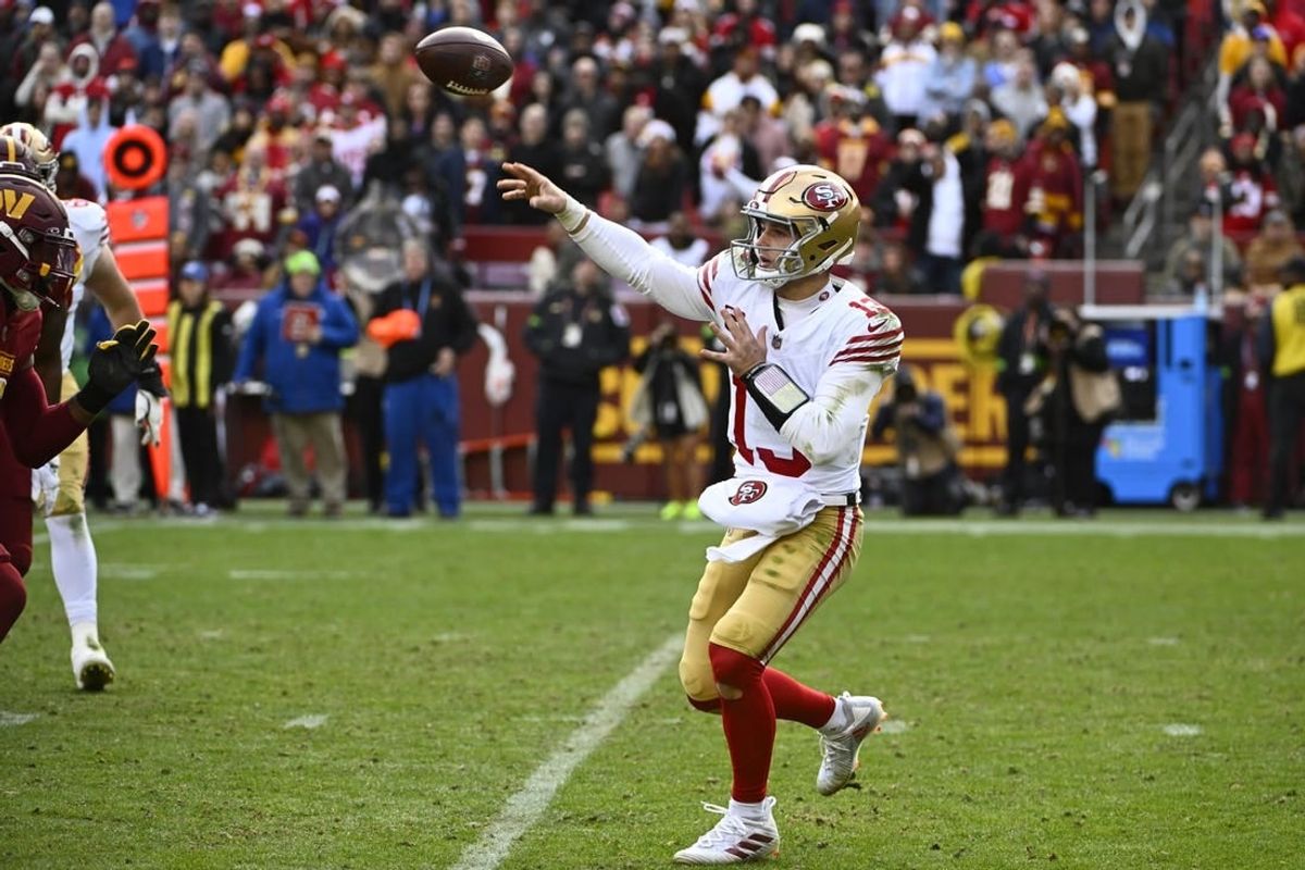 Dec 31, 2023; Landover, Maryland, USA; San Francisco 49ers quarterback Brock Purdy (13) attempts a pass against the Washington Commanders during the second half at FedExField.