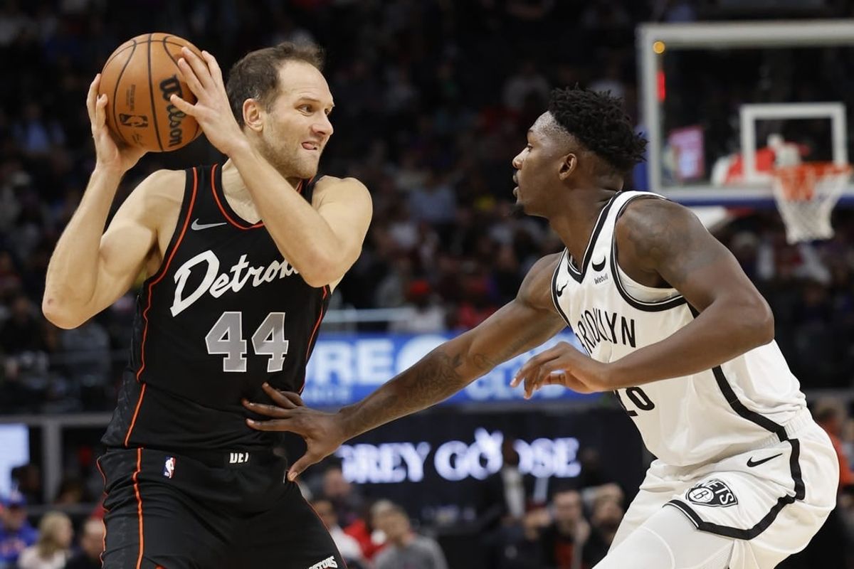 Dec 26, 2023; Detroit, Michigan, USA; Detroit Pistons forward Bojan Bogdanovic (44) is defended by Brooklyn Nets forward Dorian Finney-Smith (28) in the first half at Little Caesars Arena.