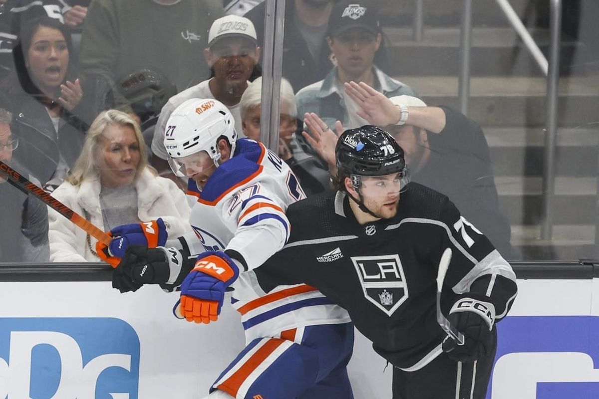 Apr 28, 2024; Los Angeles, California, USA; Los Angeles Kings right wing Alex Laferriere (78) checks Edmonton Oilers defensemen Brett Kulak (27) into the glass during the third period of game four of the first round of the 2024 Stanley Cup Playoffs at Crypto.com Arena.