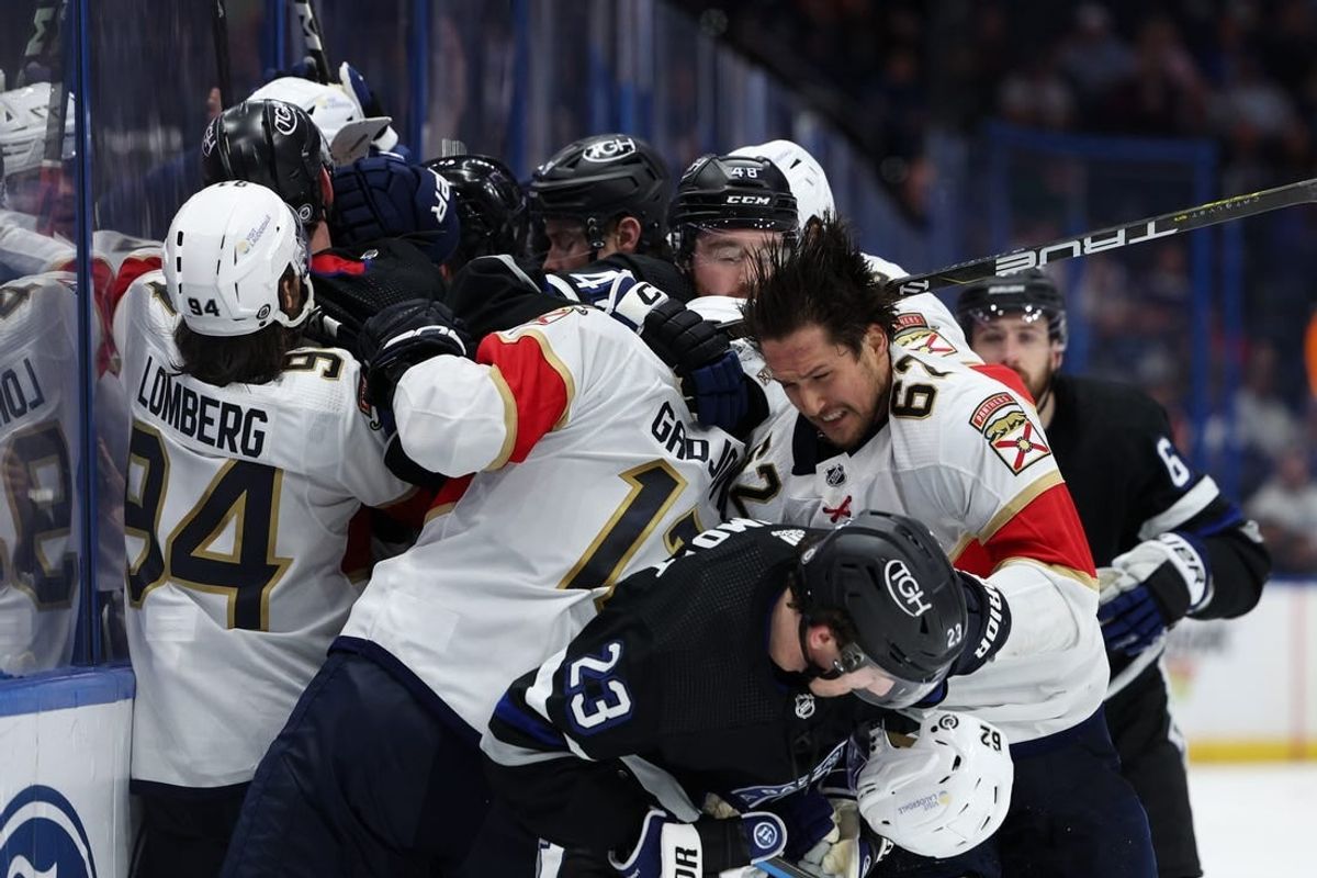 Feb 17, 2024; Tampa, Florida, USA;  the Tampa Bay Lightning and Florida Panthers scuffle on the boards in the third period at Amalie Arena.