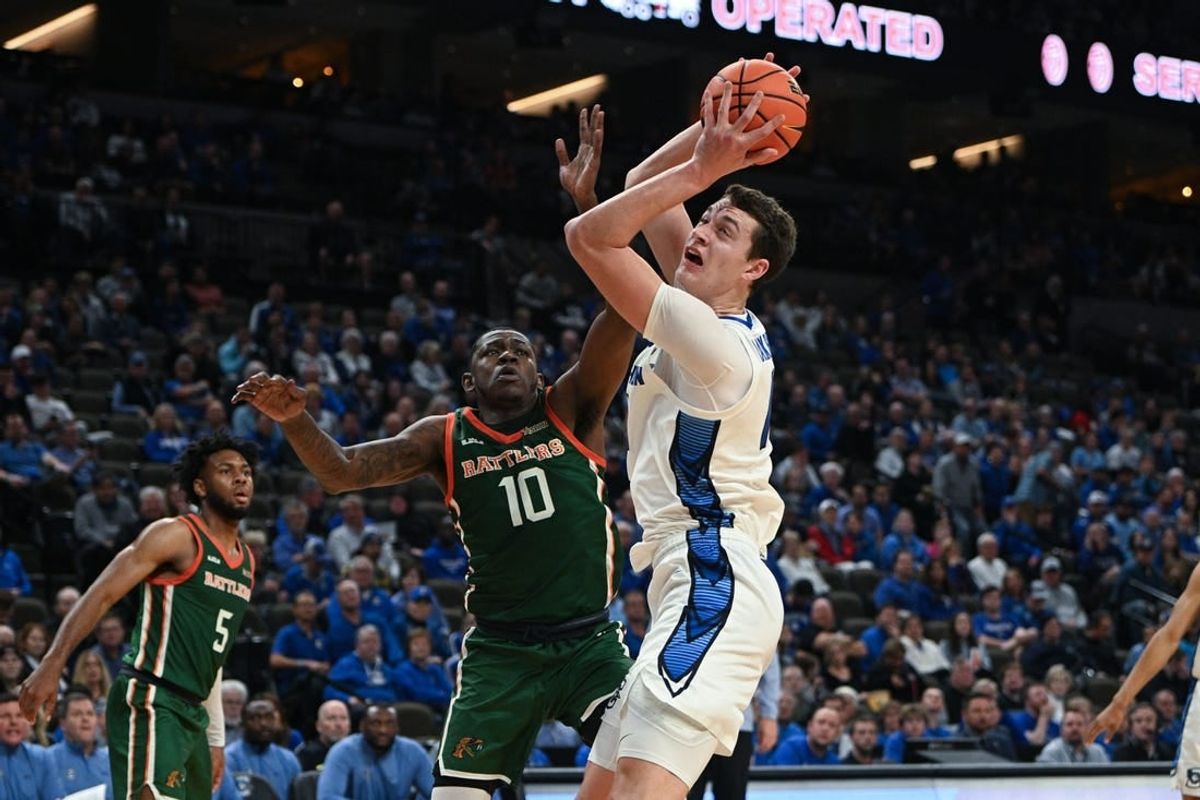 Nov 7, 2023; Omaha, Nebraska, USA; Creighton Bluejays center Ryan Kalkbrenner (11) drives against Florida A&M Rattlers forward Chase Barrs (10) in the second half at CHI Health Center Omaha.