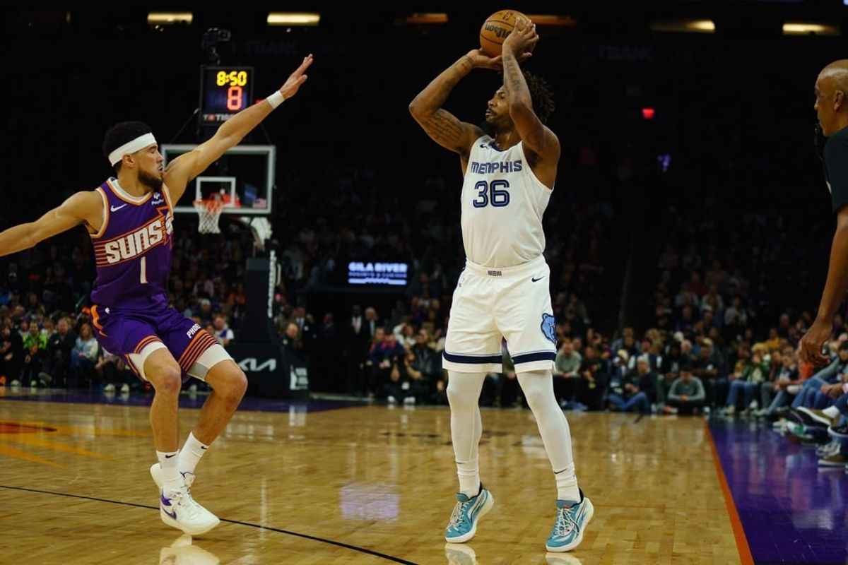 Jan 7, 2024; Phoenix, Arizona, USA;  Memphis Grizzlies guard Marcus Smart (36) squares up against Phoenix Suns guard Devin Booker (1) during the first quarter at Footprint Center.