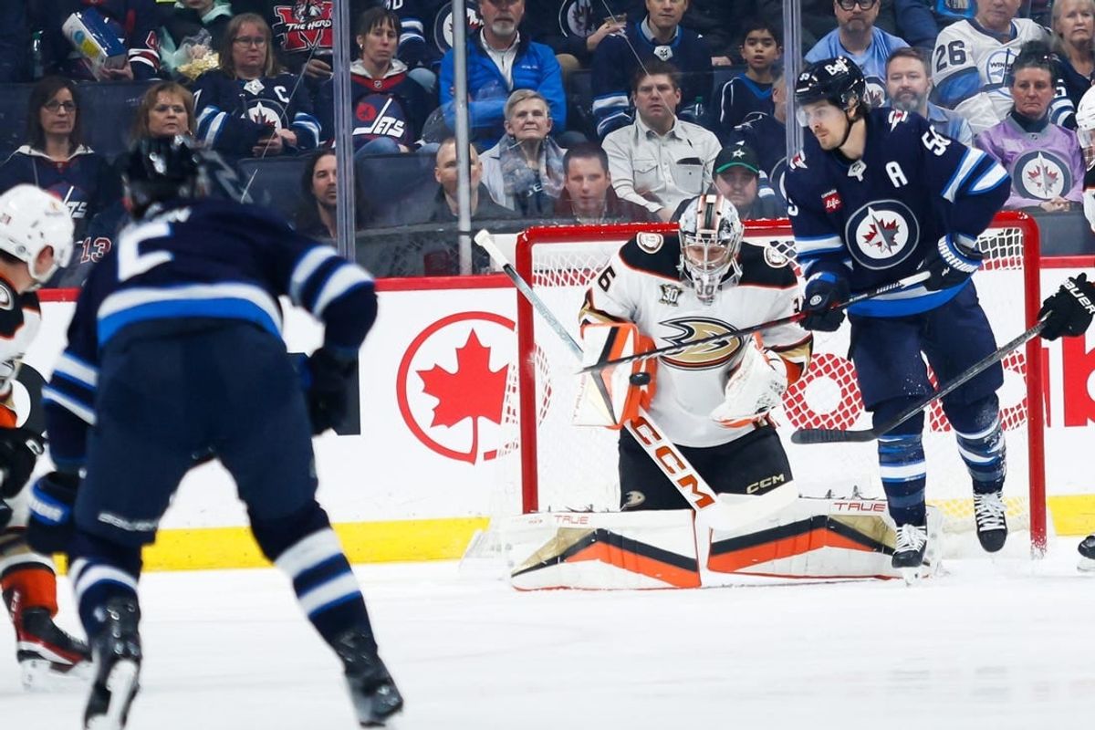 Mar 15, 2024; Winnipeg, Manitoba, CAN; Anaheim Ducks goalie John Gibson (36) makes a save on a shot by Winnipeg Jets defenseman Dylan DeMelo (2) during the first period at Canada Life Centre.