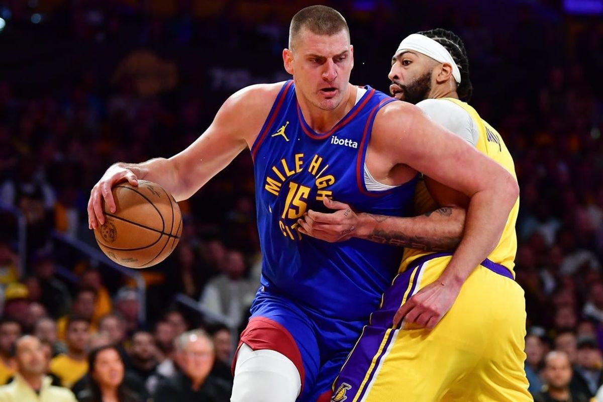 Apr 25, 2024; Los Angeles, California, USA; Denver Nuggets center Nikola Jokic (15) moves the ball against Los Angeles Lakers forward Anthony Davis (3) during the first half in game three of the first round for the 2024 NBA playoffs at Crypto.com Arena.