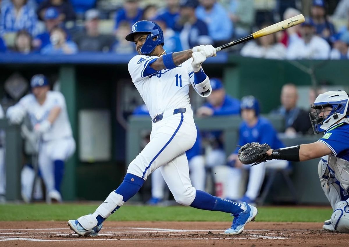 Apr 23, 2024; Kansas City, Missouri, USA; Kansas City Royals third base Maikel Garcia (11) hits a single against the Toronto Blue Jays during the first inning at Kauffman Stadium.