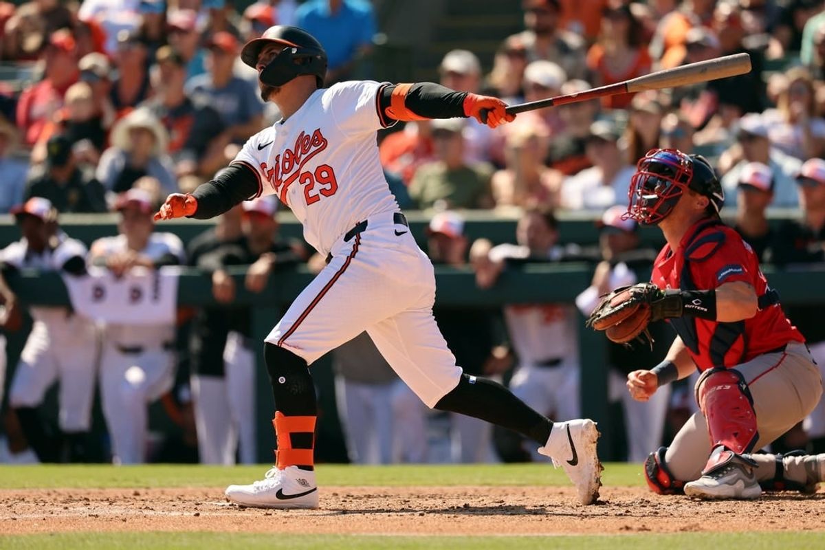 Feb 24, 2024; Sarasota, Florida, USA; Baltimore Orioles third baseman Ramon Urias (29) hits a sacrifice RBI during the fourth inning against the Boston Red Sox at Ed Smith Stadium.
