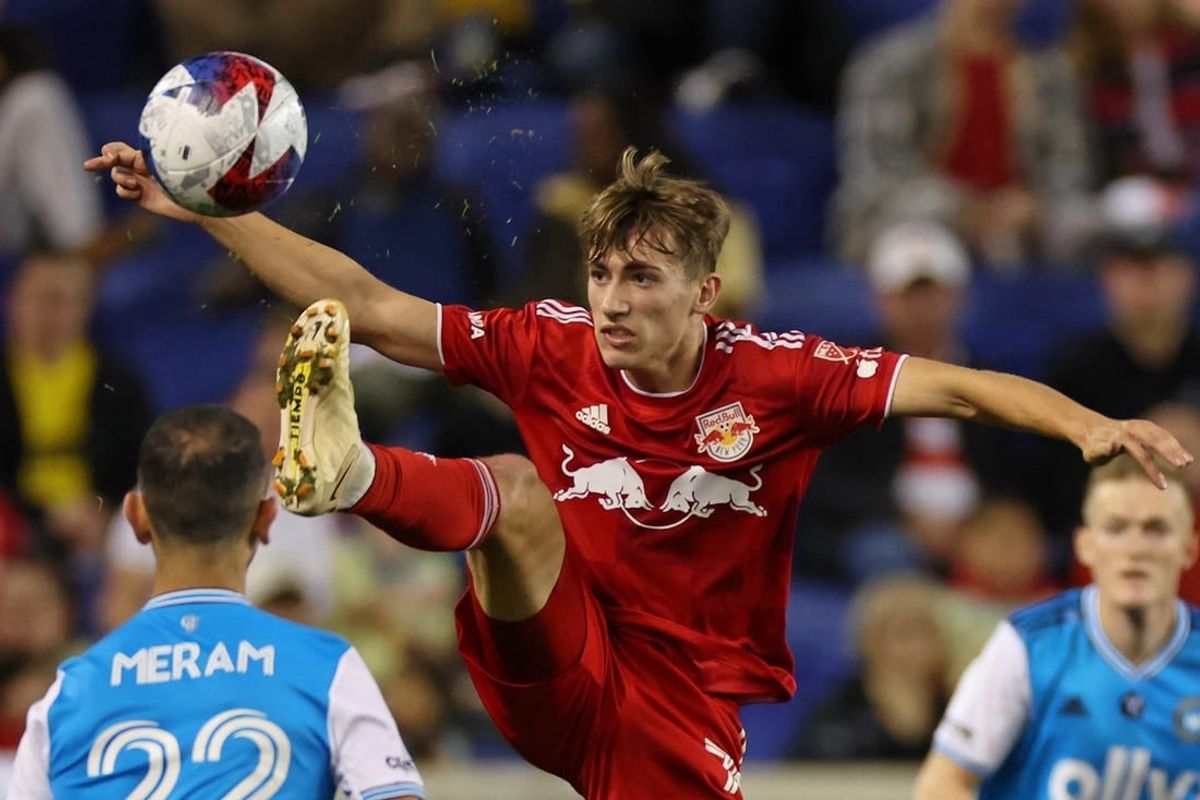 Oct 25, 2023; Harrison, NJ, USA; New York Red Bulls midfielder Daniel Edelman (75) kicks the ball against Charlotte FC forward Justin Meram (22) during the second half in the Eastern Conference Wild Card match of the 2023 MLS Cup Playoffs at Red Bull Arena.