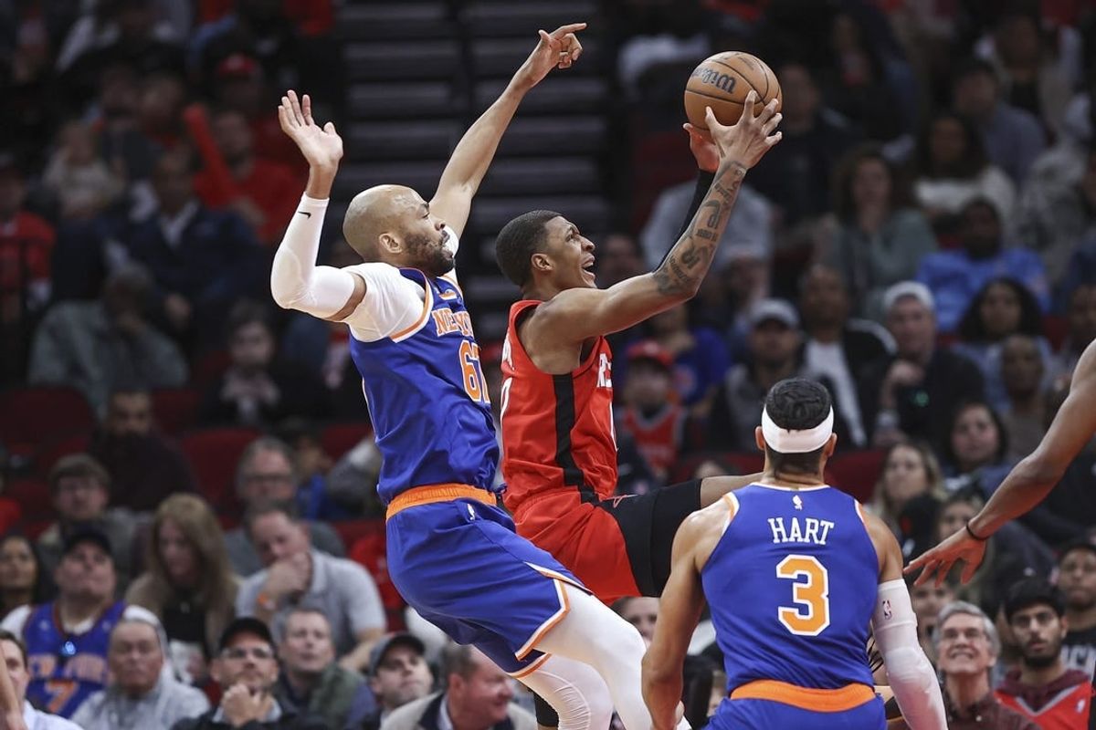 Feb 12, 2024; Houston, Texas, USA; Houston Rockets forward Jabari Smith Jr. (10) grabs a rebound away from New York Knicks forward Taj Gibson (67) during the second quarter at Toyota Center.