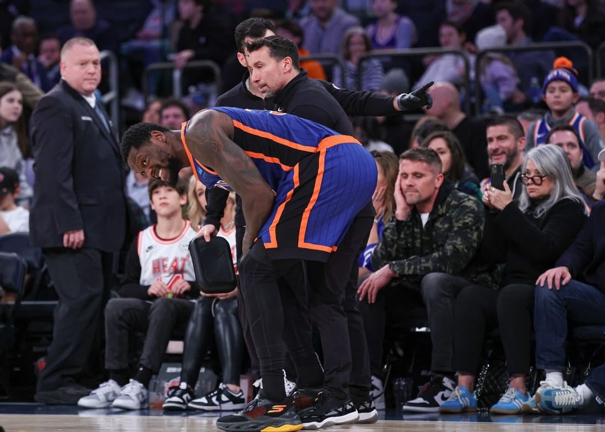 Jan 27, 2024; New York, New York, USA; New York Knicks forward Julius Randle (30) is helped by medical staff after an injury during the second half against the Miami Heat at Madison Square Garden.