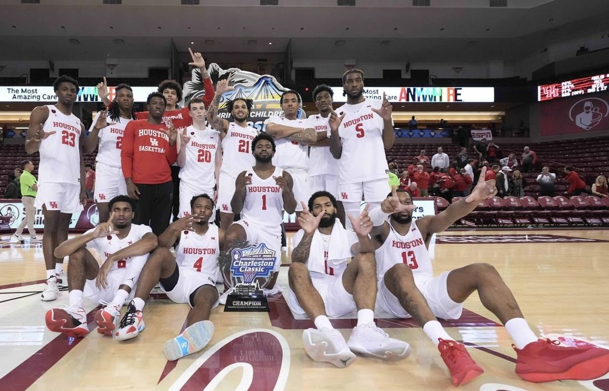 Nov 19, 2023; Charleston, SC, USA; The Houston Cougars with the champions trophy after winning the 2023 Charleston Classic at TD Arena.