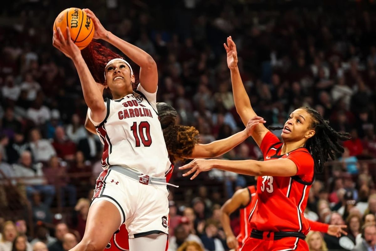 Feb 18, 2024; Columbia, South Carolina, USA; South Carolina Gamecocks center Kamilla Cardoso (10) shoots over Georgia Lady Bulldogs forward Destiny Thomas (33) in the first half at Colonial Life Arena.