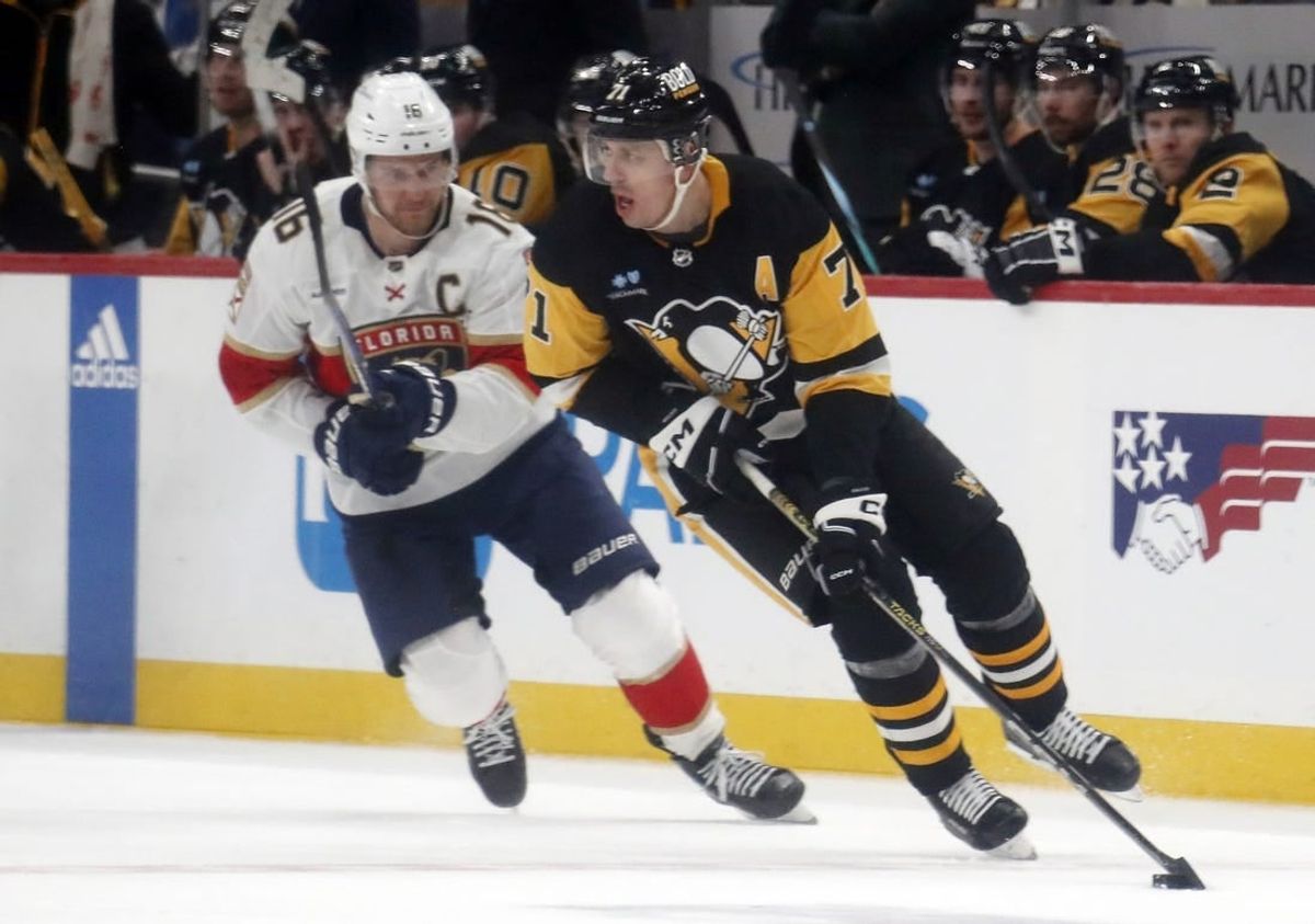 Jan 26, 2024; Pittsburgh, Pennsylvania, USA; Pittsburgh Penguins center Evgeni Malkin (71) moves the puck against Florida Panthers center Aleksander Barkov (16) during the second period at PPG Paints Arena.