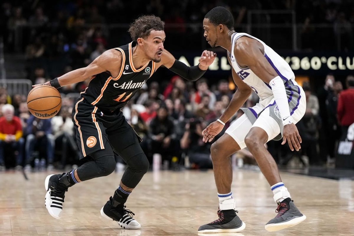 Nov 23, 2022; Atlanta, Georgia, USA; Atlanta Hawks guard Trae Young (11) dribbles against Sacramento Kings guard De'Aaron Fox (5) during the second half at State Farm Arena.