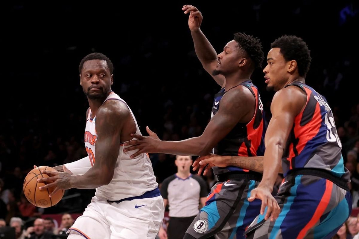 Dec 20, 2023; Brooklyn, New York, USA; New York Knicks forward Julius Randle (30) controls the ball against Brooklyn Nets forward Dorian Finney-Smith (28) and center Nic Claxton (33) during the first quarter at Barclays Center.