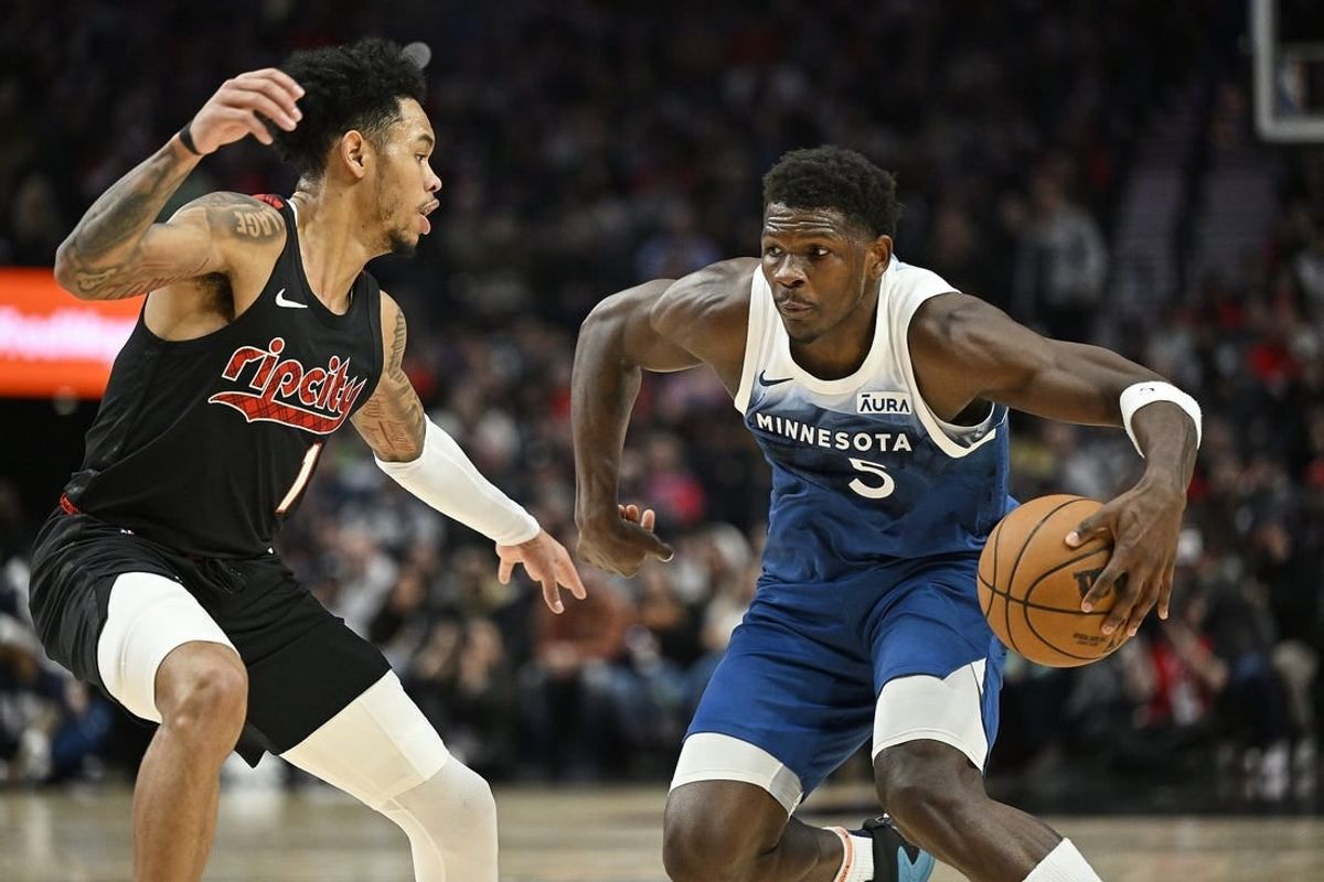 Feb 15, 2024; Portland, Oregon, USA; Minnesota Timberwolves guard Anthony Edwards (5) drives to the basket during the first half against Portland Trail Blazers guard Anfernee Simons (1) at Moda Center.