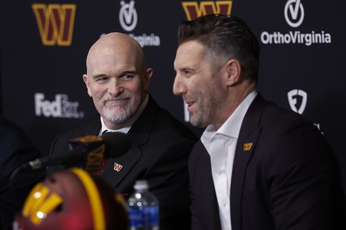 Feb 5, 2024; Ashburn, VA, USA; Washington Commanders head coach Dan Quinn (L) smiles as Commanders general manager Adam Peters (R) speaks during Quinn's introductory press conference at Commanders Park.