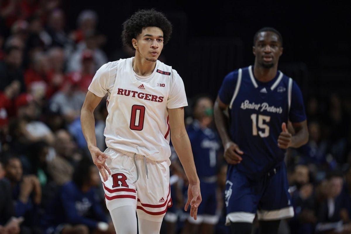 Nov 27, 2023; Piscataway, New Jersey, USA;  Rutgers Scarlet Knights guard Derek Simpson (0) reacts after making a three point basket in front of St. Peter's Peacocks forward Stephon Roberts (15) during the first half at Jersey Mike's Arena.