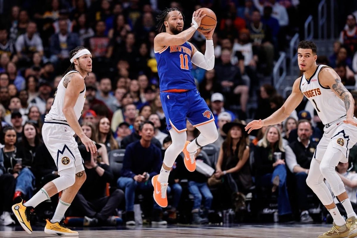 Mar 21, 2024; Denver, Colorado, USA; New York Knicks guard Jalen Brunson (11) controls the ball as Denver Nuggets forward Aaron Gordon (50) and ]forward Michael Porter Jr. (1) defend in the first quarter at Ball Arena.
