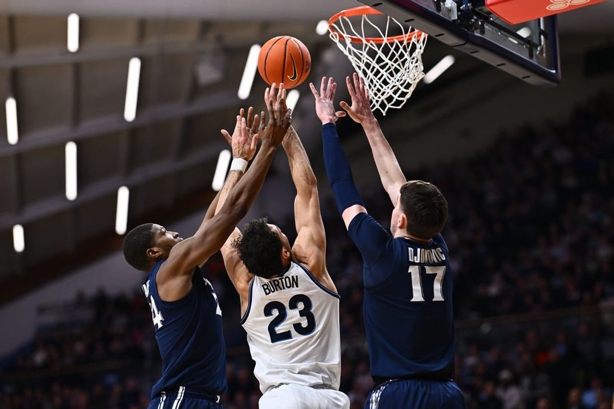 Jan 3, 2024; Villanova, Pennsylvania, USA; Villanova Wildcats forward Tyler Burton (23) reaches for a rebound between Xavier Musketeers forward Abou Ousmane (24) and forward Lazar Djokovic (17) in the first half at William B. Finneran Pavilion.