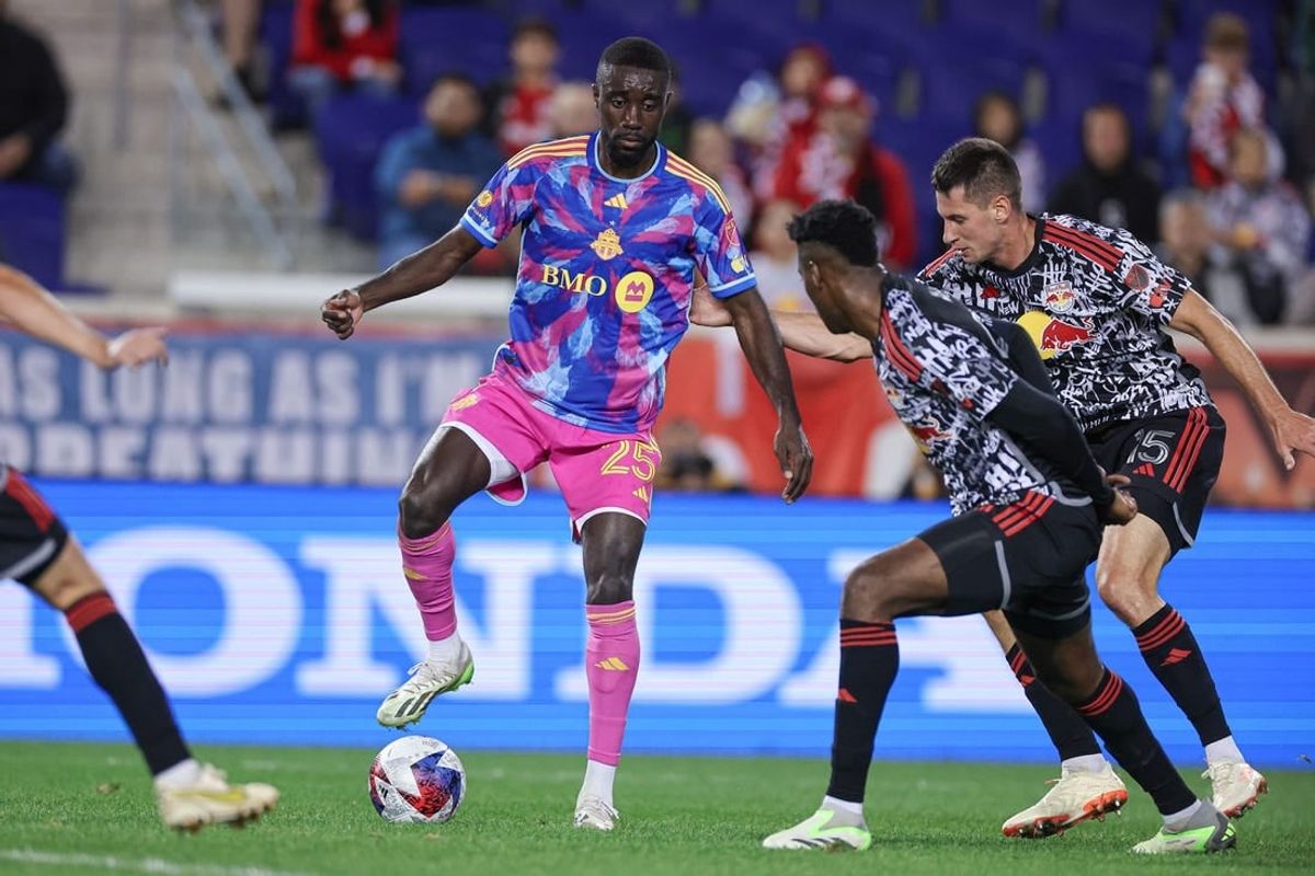Oct 7, 2023; Harrison, New Jersey, USA; Toronto FC forward Prince Osei Owusu (25) controls the ball as New York Red Bulls defender Hassan Ndam (98) and defender Sean Nealis (15) defend during the first half at Red Bull Arena.