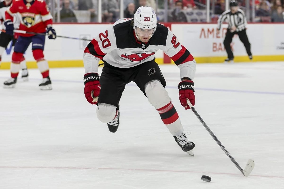 Jan 13, 2024; Sunrise, Florida, USA; New Jersey Devils center Michael McLeod (20) moves the puck against the Florida Panthers during the first period at Amerant Bank Arena.