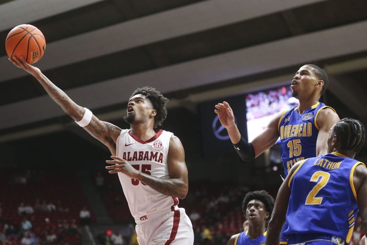 Nov 6, 2023; Tuscaloosa, Alabama, USA;  Alabama guard Aaron Estrada drives and scores past Morehead State guard Kalil Thomas (15) and Morehead State guard Jordan Lathon (2) in the game at Coleman Coliseum.