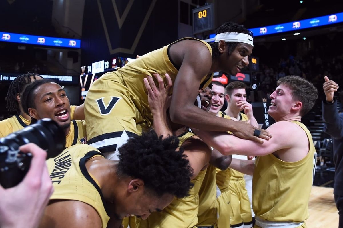 Feb 13, 2024; Nashville, Tennessee, USA; Vanderbilt Commodores guard Ezra Manjon (5) celebrates with teammates after making the game-winning basket against the Texas A&M Aggies at Memorial Gymnasium.