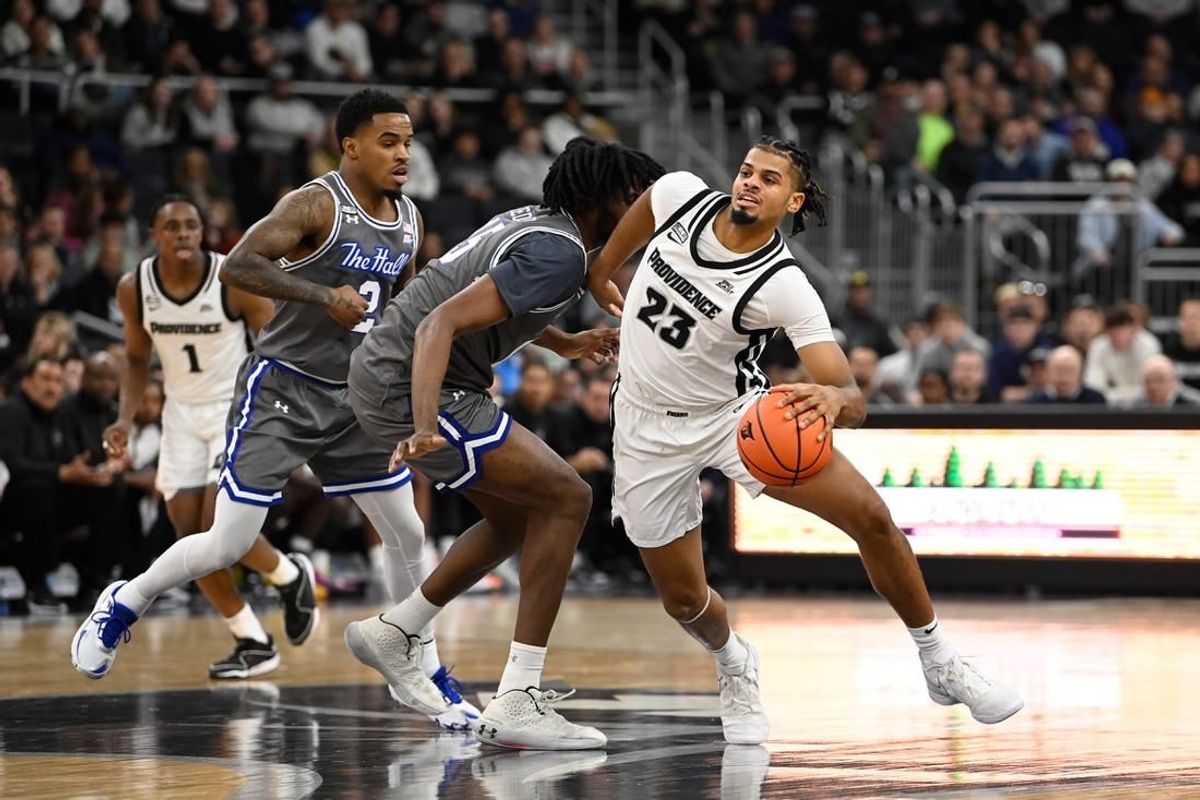 Jan 3, 2024; Providence, Rhode Island, USA; Providence Friars forward Bryce Hopkins (23) drives the ball through Seton Hall Pirates center Jaden Bediako (15) during the first half at Amica Mutual Pavilion.