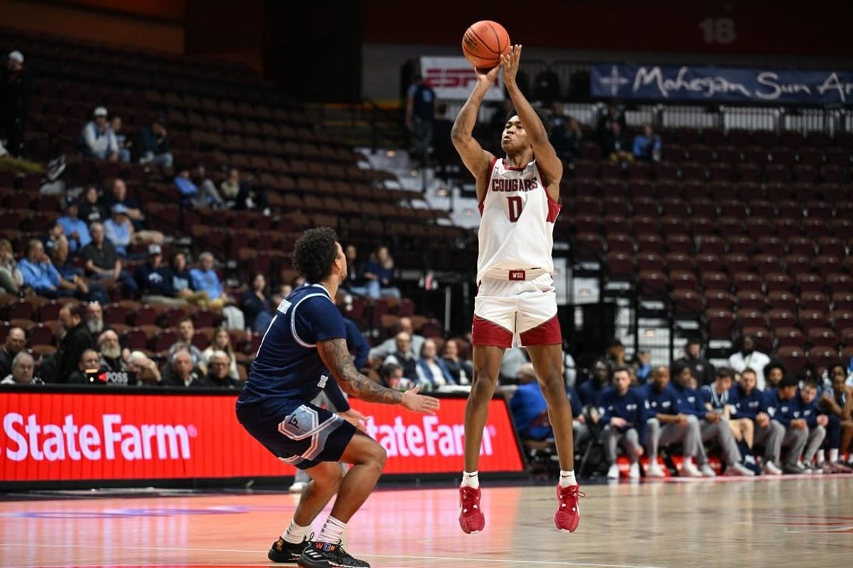 Nov 19, 2023; Uncasville, CT, USA; Washington State Cougars forward Jaylen Wells (0) shoots the ball over Rhode Island Rams guard Luis Kortright (1) during the second half at Mohegan Sun Arena.