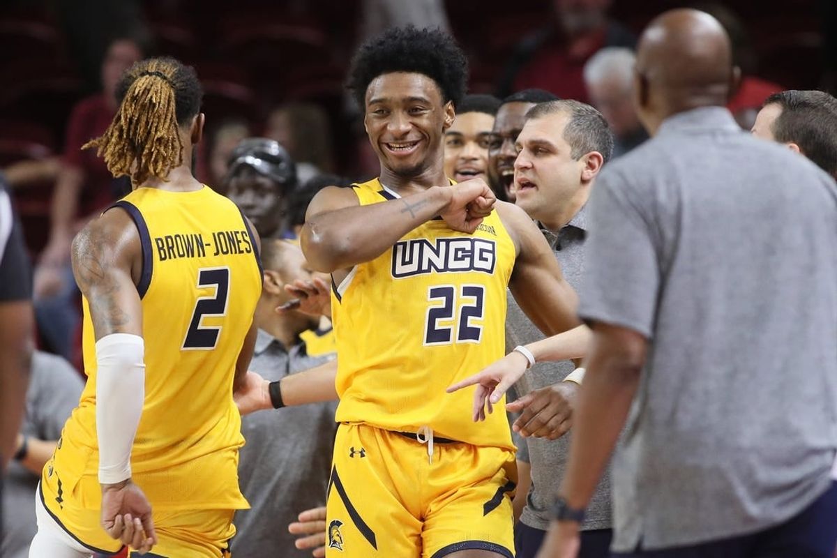 Nov 17, 2023; Fayetteville, Arkansas, USA; UNC Greensboro Spartans forwards Mikel Brown-Jones (2) and Jalen Breath (22) celebrate near the end of the game against the Arkansas Razorbacks at Bud Walton Arena. Spartans won 78-72.