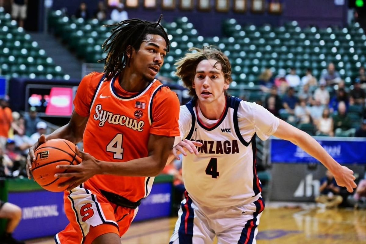 Nov 21, 2023; Honolulu, HI, USA;  Syracuse Orange forward Chris Bell (4) drives to the basket defended by Gonzaga Bulldogs guard Dusty Stromer (4) during the first period at SimpliFi Arena at Stan Sheriff Center.