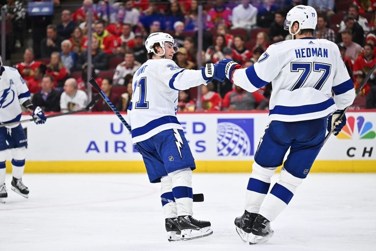 Nov 16, 2023; Chicago, Illinois, USA; Tampa Bay Lightning forward Brayden Point (21) celebrates with defenseman Victor Hedman (77) after scoring a goal in the second period against the Chicago Blackhawks at United Center.