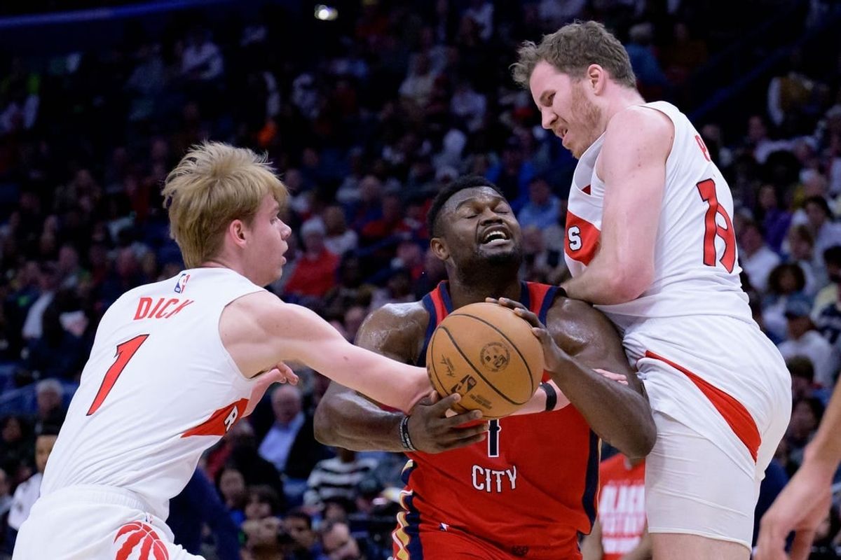 Feb 5, 2024; New Orleans, Louisiana, USA; Toronto Raptors guard Gradey Dick (1) and Toronto Raptors center Jakob Poeltl (19) double team New Orleans Pelicans forward Zion Williamson (1) during the first half at Smoothie King Center.