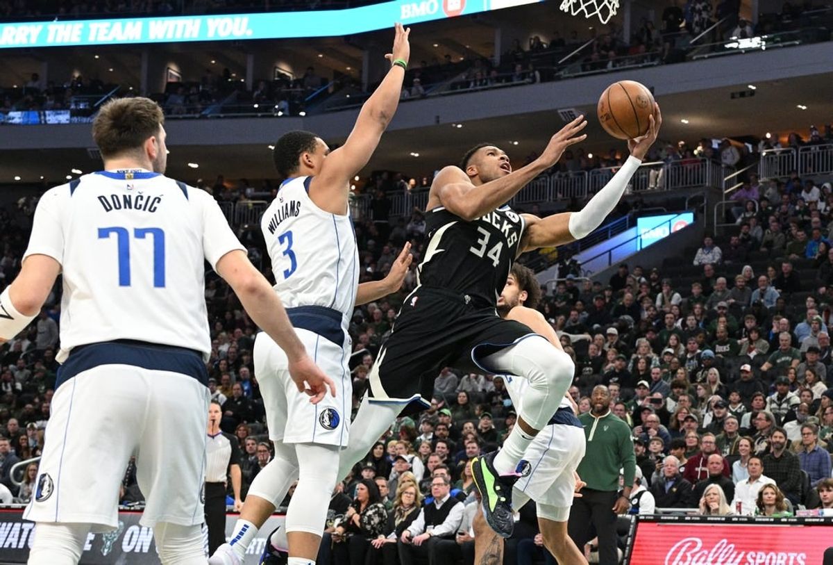 Nov 18, 2023; Milwaukee, Wisconsin, USA; Milwaukee Bucks forward Giannis Antetokounmpo (34) drives to the basket against Dallas Mavericks forward Grant Williams (3) in the first half at Fiserv Forum.