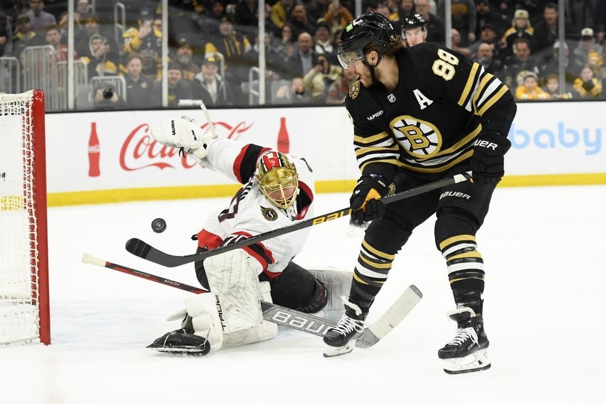Mar 19, 2024; Boston, Massachusetts, USA;  Boston Bruins right wing David Pastrnak (88) scores a goal past Ottawa Senators goaltender Joonas Korpisalo (70) during the first period at TD Garden.