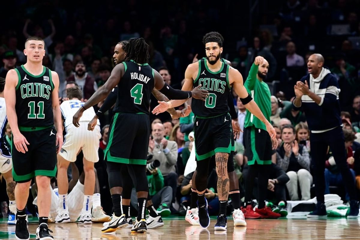 Dec 15, 2023; Boston, Massachusetts, USA; Boston Celtics forward Jayson Tatum (0) reacts to his shot with guard Jrue Holiday (4) during the first half against the Orlando Magic at TD Garden.