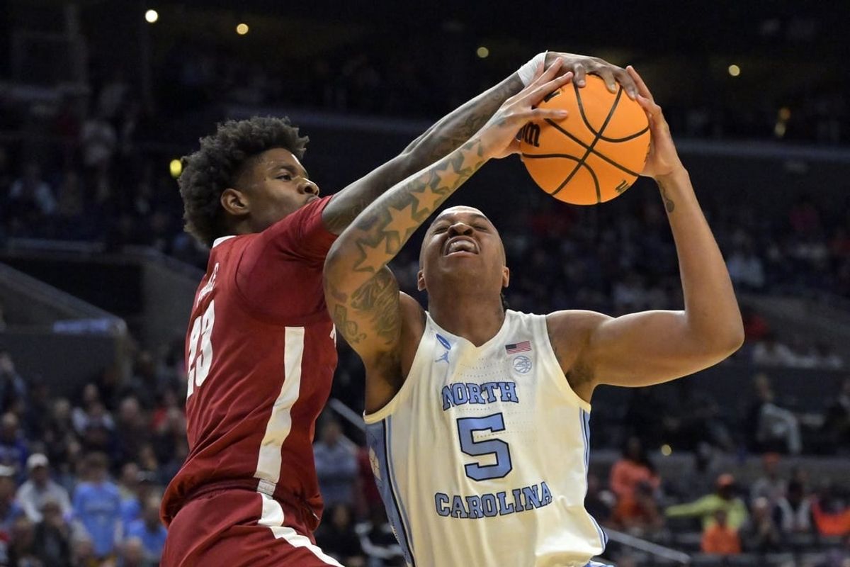 Mar 28, 2024; Los Angeles, CA, USA; Alabama Crimson Tide forward Nick Pringle (23) defends against North Carolina Tar Heels forward Armando Bacot (5) in the first half in the semifinals of the West Regional of the 2024 NCAA Tournament at Crypto.com Arena.