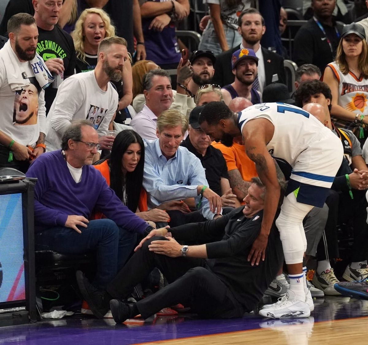 Apr 28, 2024; Phoenix, Arizona, USA; Minnesota Timberwolves guard Mike Conley (10) tends to to head coach Chris Finch after he was injured during the second half of game four of the first round for the 2024 NBA playoffs against the Phoenix Suns at Footprint Center.