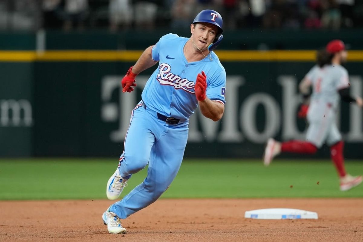 Apr 28, 2024; Arlington, Texas, USA; Texas Rangers designated hitter Wyatt Langford (36) rounds the bases on his  two-run inside the park home run against the Cincinnati Reds during the first inning at Globe Life Field. Langford picked up his first major league home run on the play.