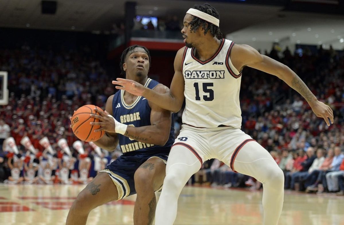Jan 30, 2024; Dayton, Ohio, USA;  George Washington forward Darren Buchanan Jr. (3) drives against Dayton Flyers forward DaRon Holmes II (15) at University of Dayton Arena.