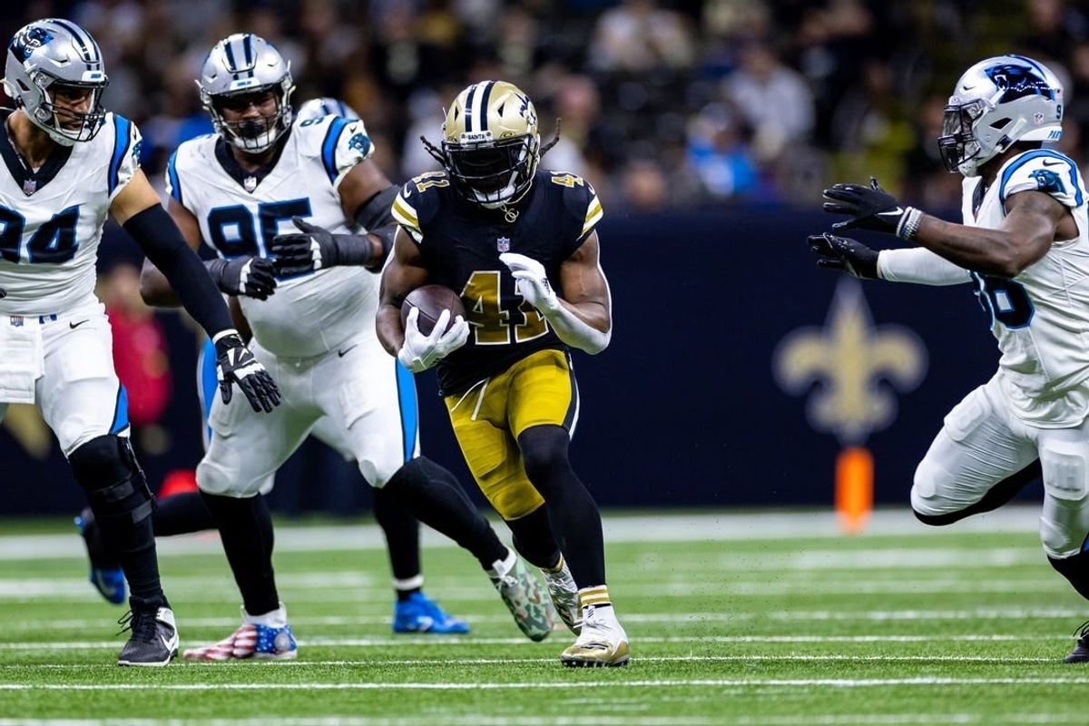 Dec 10, 2023; New Orleans, Louisiana, USA; New Orleans Saints running back Alvin Kamara (41) runs against Carolina Panthers defensive end Henry Anderson (94) during the first half at the Caesars Superdome.