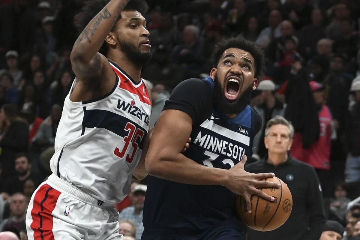 Jan 24, 2024; Washington, District of Columbia, USA; Minnesota Timberwolves center Karl-Anthony Towns (32) move to the the basket on Washington Wizards forward Marvin Bagley III (35) during the first half  at Capital One Arena.
