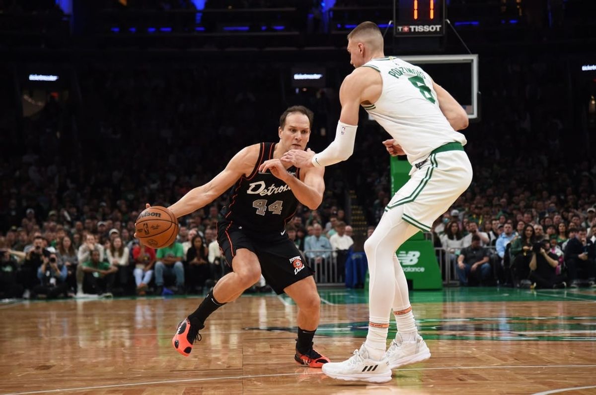 Dec 28, 2023; Boston, Massachusetts, USA;  Detroit Pistons forward Bojan Bogdanovic (44) controls the ball while Boston Celtics center Kristaps Porzingis (8) defends during the second half at TD Garden.
