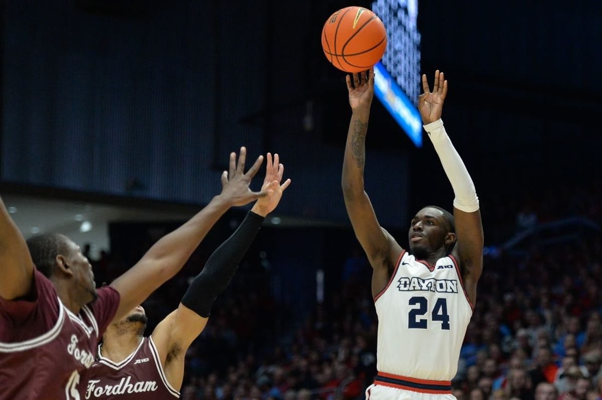 Feb 17, 2024; Dayton, Ohio, USA;  Dayton Flyers guard Kobe Elvis (24) shoots the ball against Fordham guard Antrell Charlton (24) during the game at University of Dayton Arena.